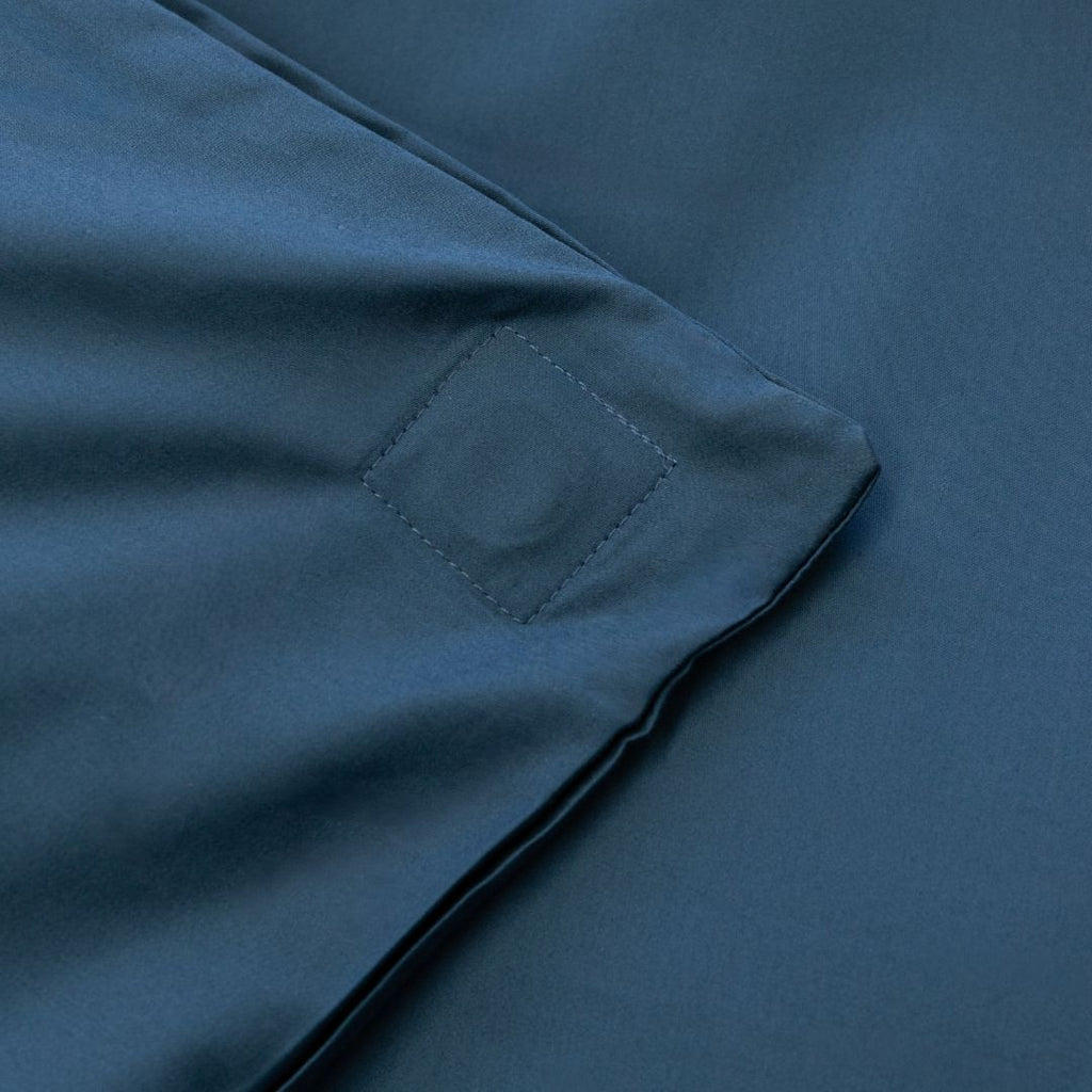 Close-up of a blue fabric with a magnetic pocket detail