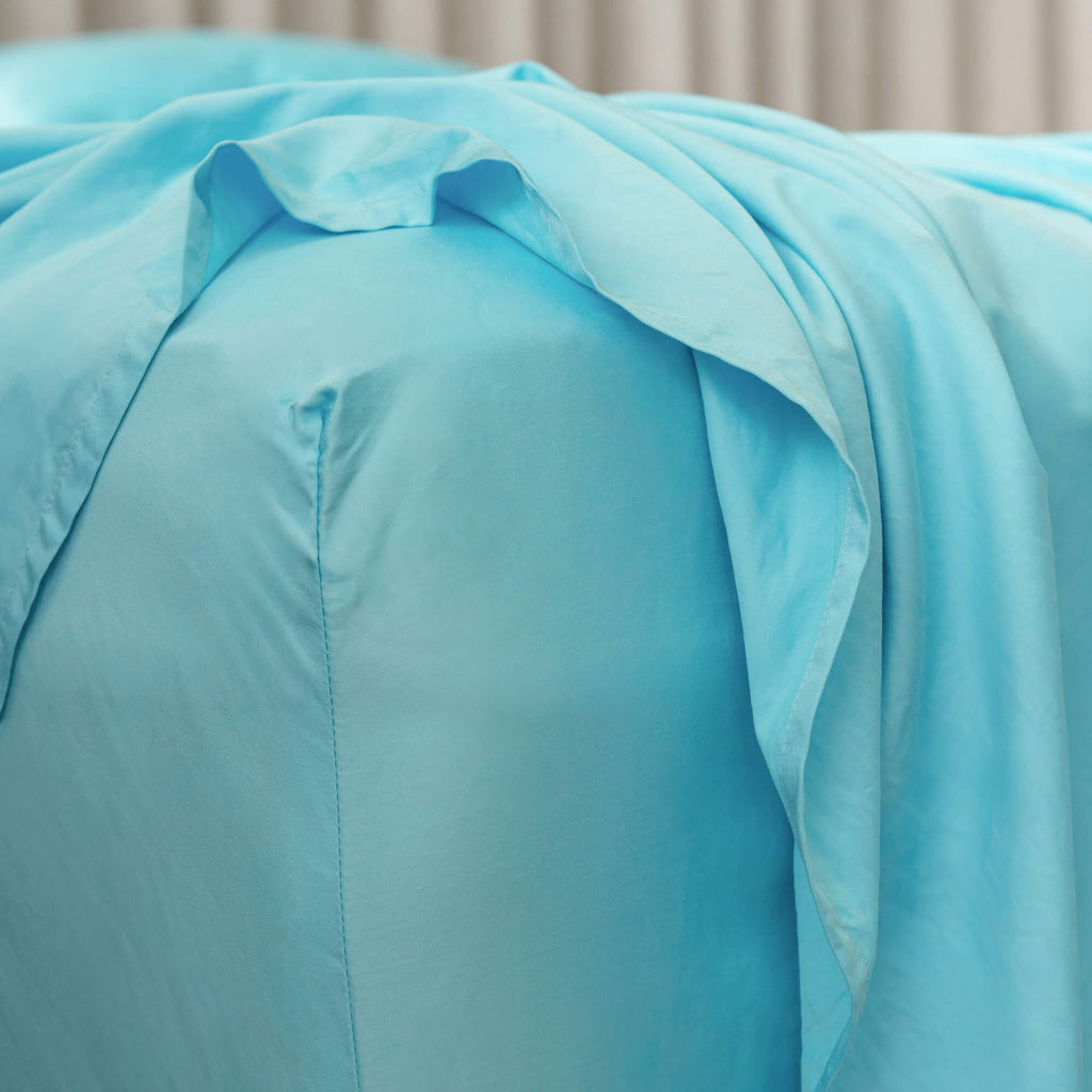 Close up of corner off fitted sheet in light blue