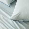 Close-up of light blue pillowcases with concealed zipper closures, showcasing the secure fastening detail and soft brushed fabric texture.