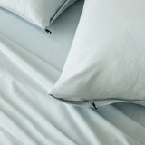 Close-up of light blue pillowcases with concealed zipper closures, showcasing the secure fastening detail and soft brushed fabric texture.