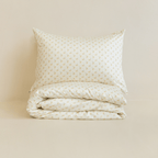 Neatly folded cream floral print quilt cover with one matching pillowcase resting on top