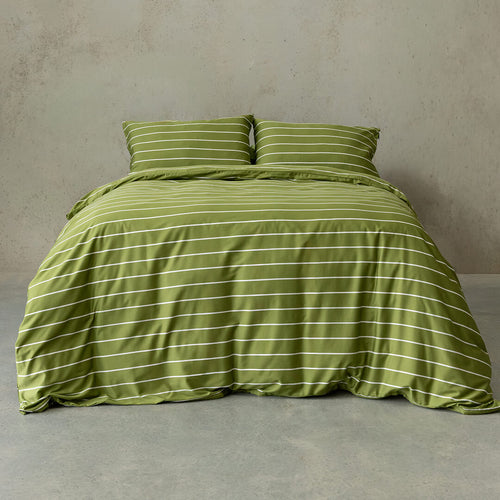 Green striped bedding set on a bed against a plain wall.