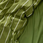 Close-up of green fabric with white stripes.