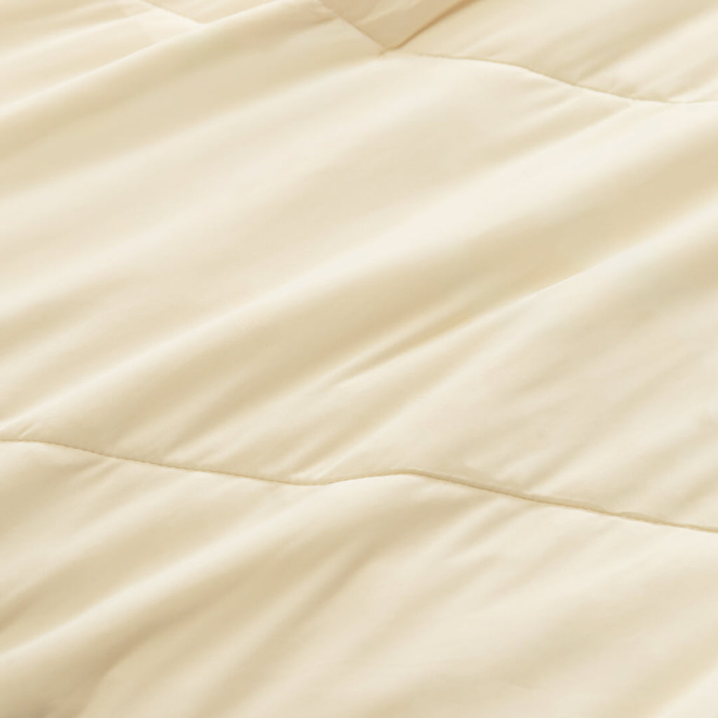 Close up of fabric texture on the beige / cream coloured cooling blanket.