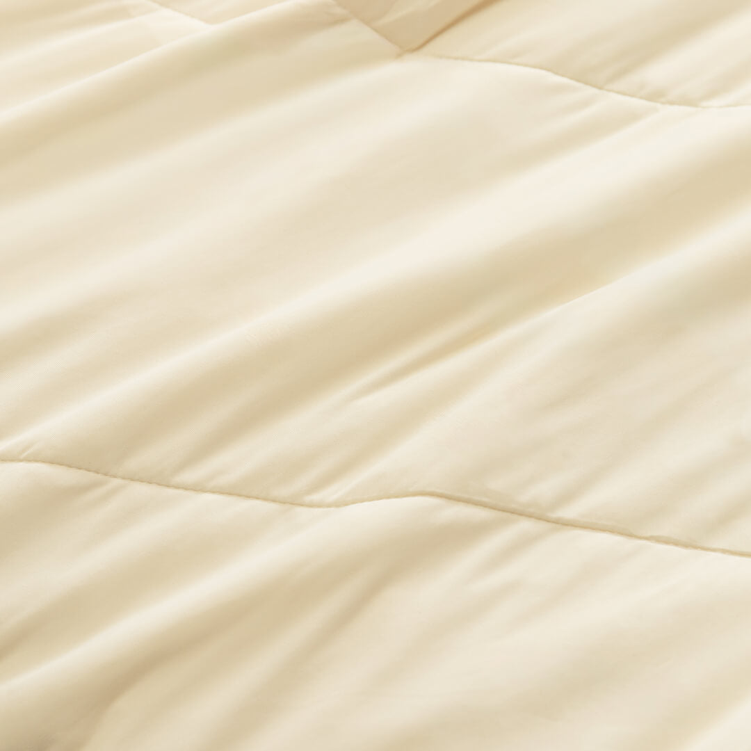 Close up of fabric texture on the beige / cream coloured cooling blanket.