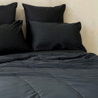 Black cooling blanket on bed.