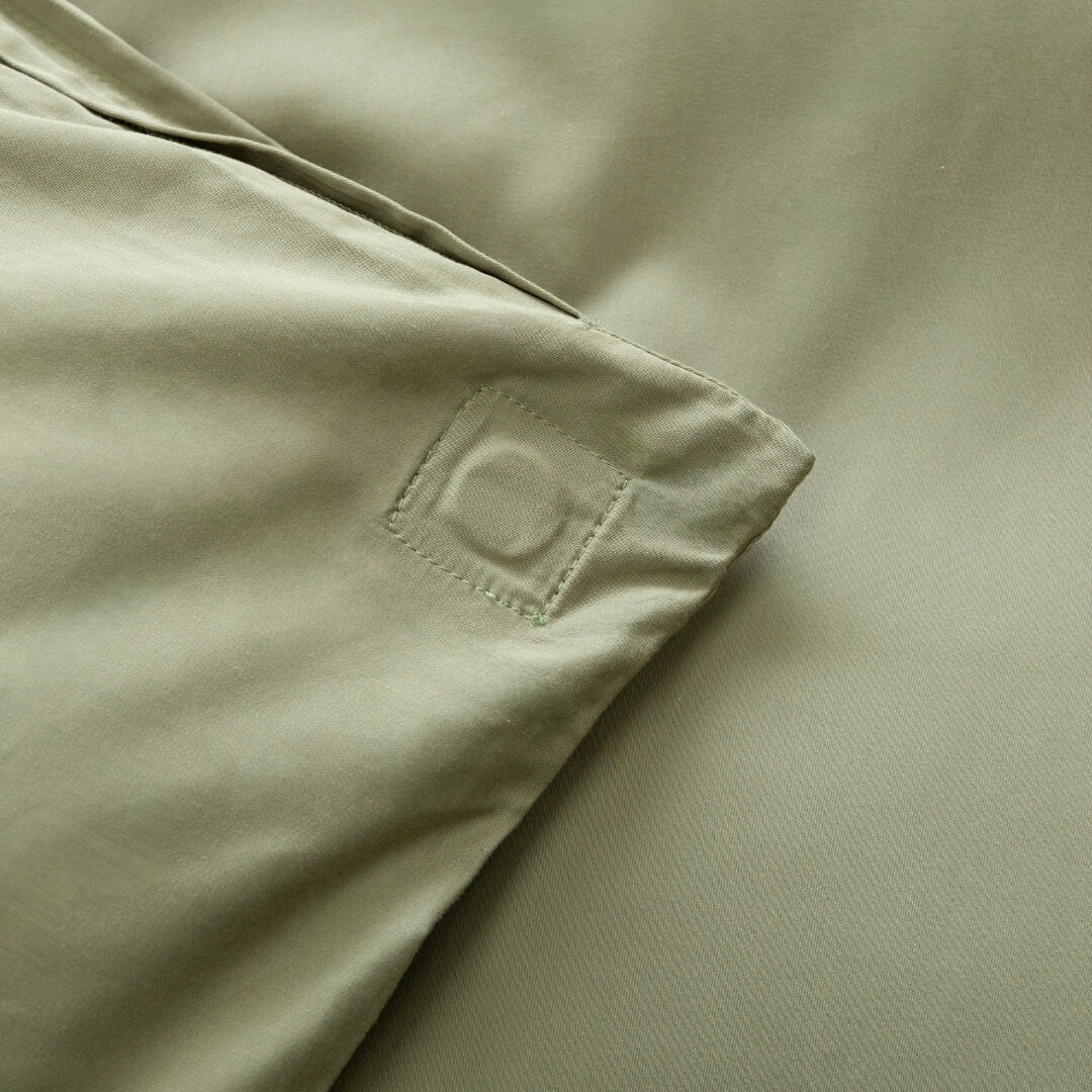 Sage green quilt cover magnetic corner close-up.