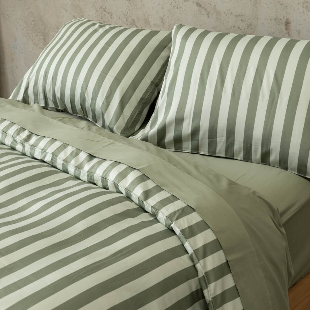 Sage green stripe quilt cover set, focusing on the two matching pillowcases.