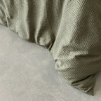 Textured green quilt cover corner.