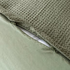 Close-up of a quilt cover with a textured surface and zipper detail.