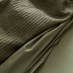 Close-up of textured fabric with a draped section.