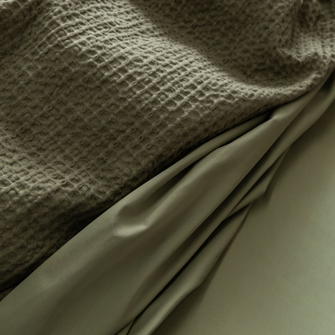 Close-up of textured fabric with a draped section.