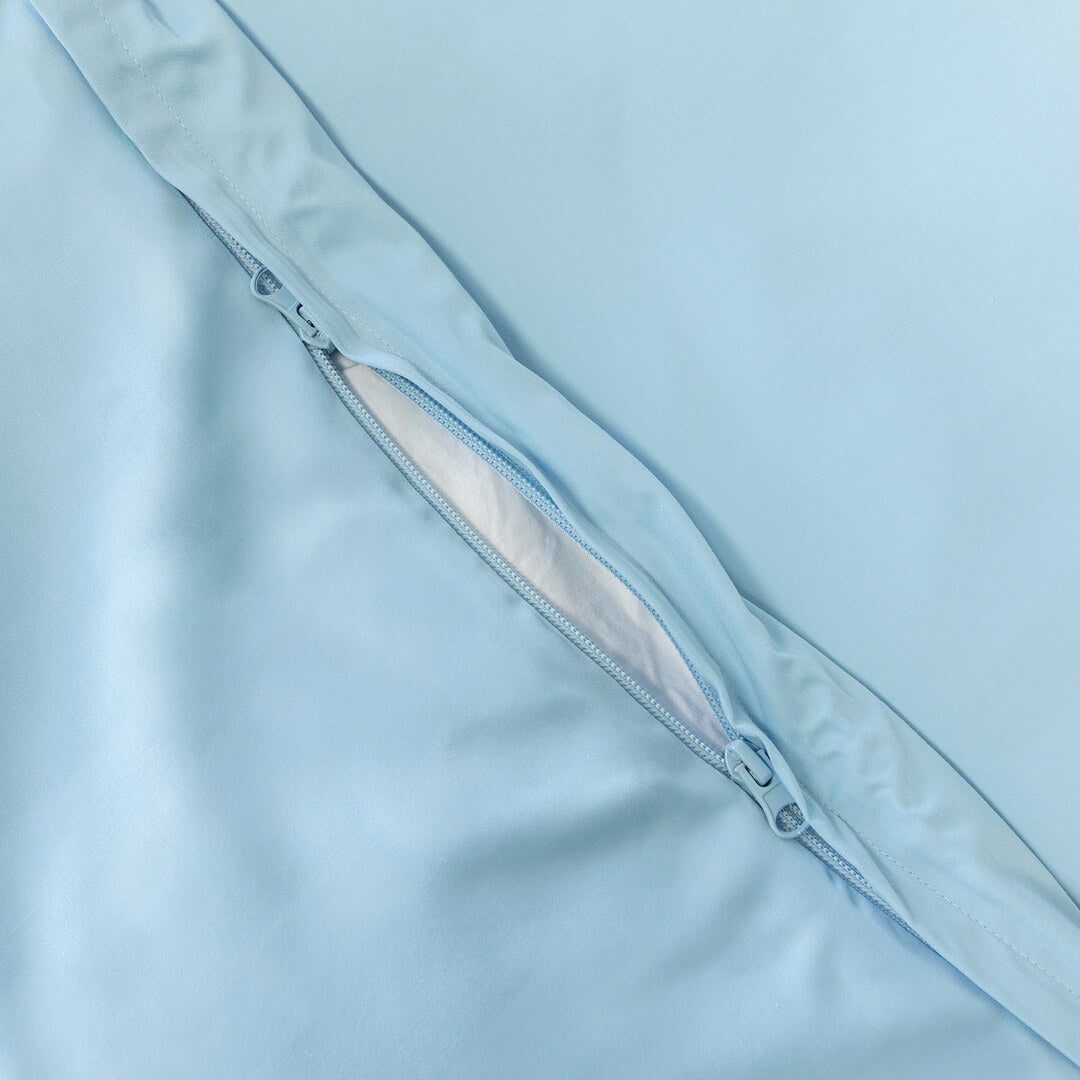 Pastel blue quilt cover zip close up.
