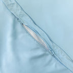 Pastel blue quilt cover zip close up.