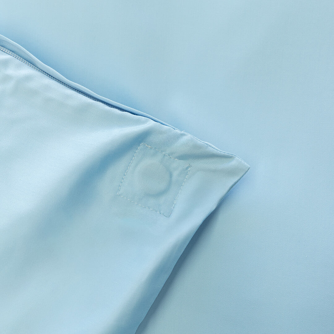 Pastel blue quilt cover magnetic corner close up.