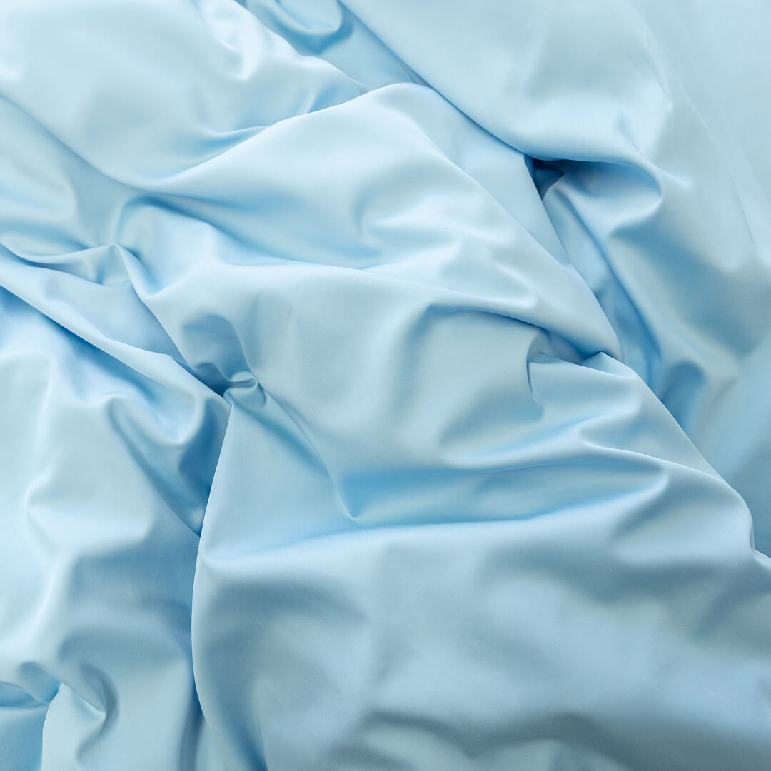 Pastel blue quilt cover set material close up.