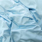 Pastel blue quilt cover set material close up.