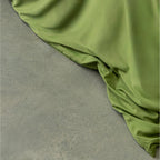 Green fabric draped over a gray surface.