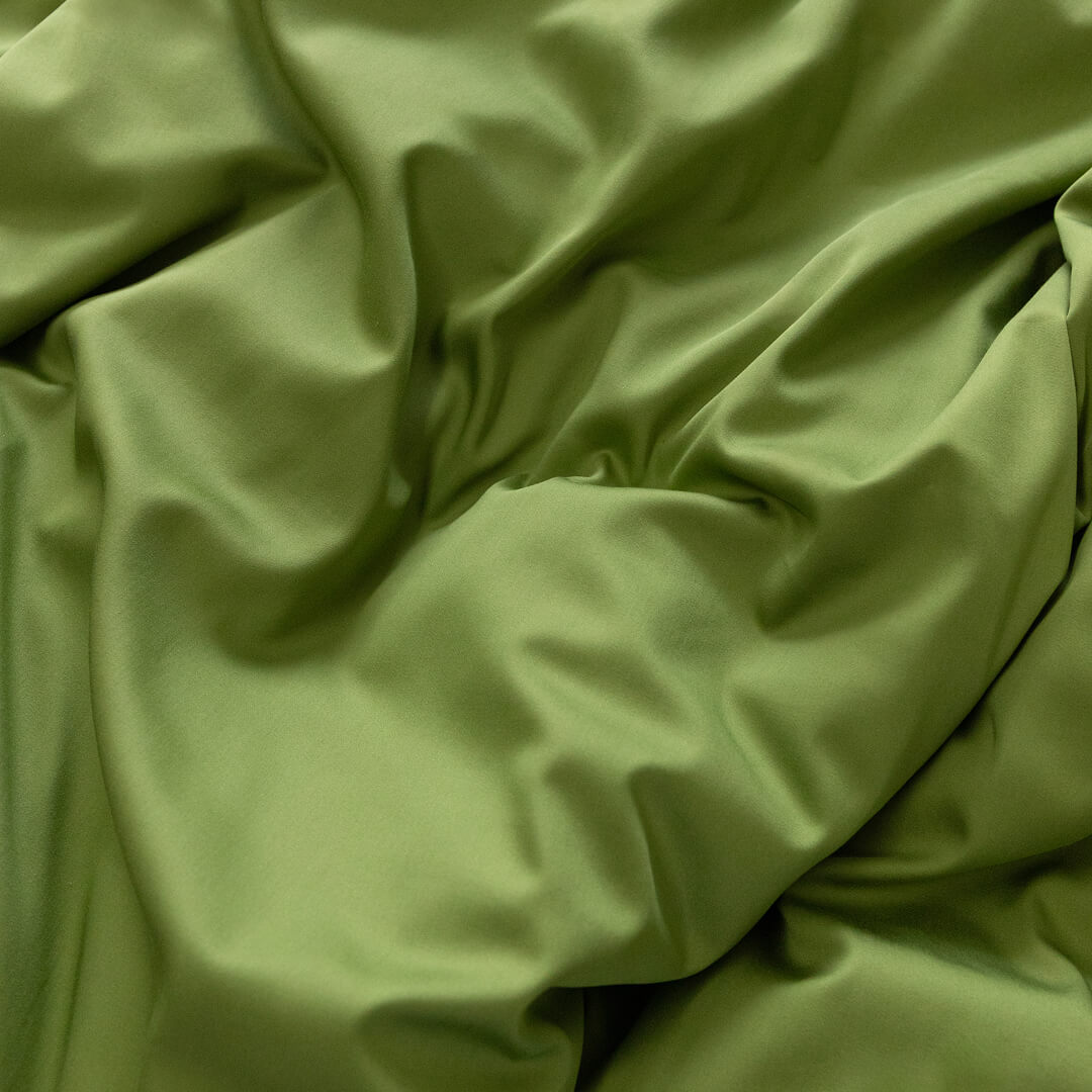 Close-up of green fabric with folds.