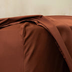 Chocolate brown fitted sheet close up of corner.
