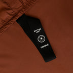 Chocolate brown fitted sheet labelled corner strap.