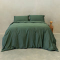 Dark green quilt cover set on a bed.