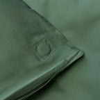Close-up of green fabric with a corner magnet.