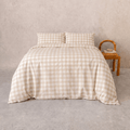 Beige gingham quilt cover set styled on a bed with matching pillowcases, featuring a timeless checkered pattern, soft drape, and warm neutral tones for a cozy bedroom aesthetic.