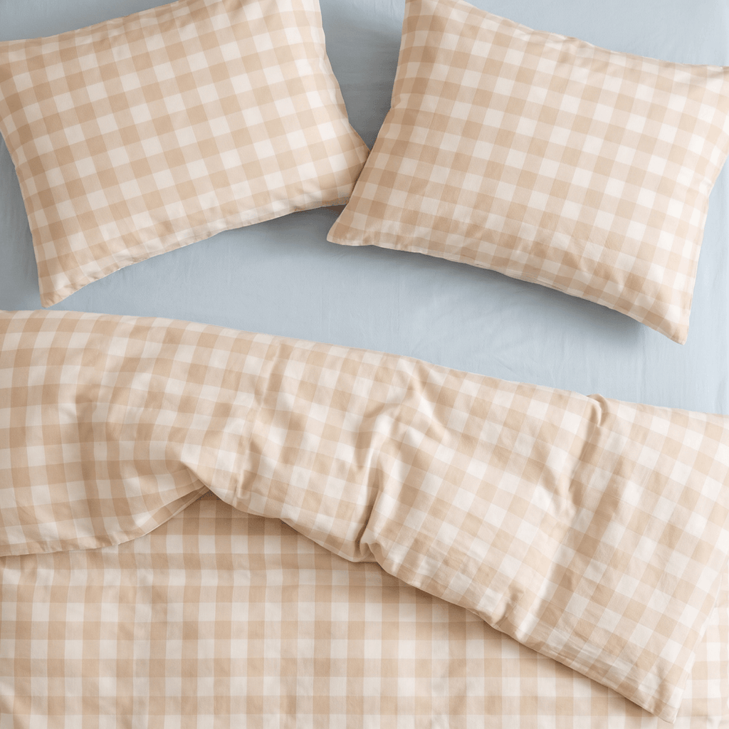 Overhead view of the beige gingham quilt cover and matching pillowcases, showcasing the coordinated checkered pattern, smooth fabric, and neatly styled bedding.