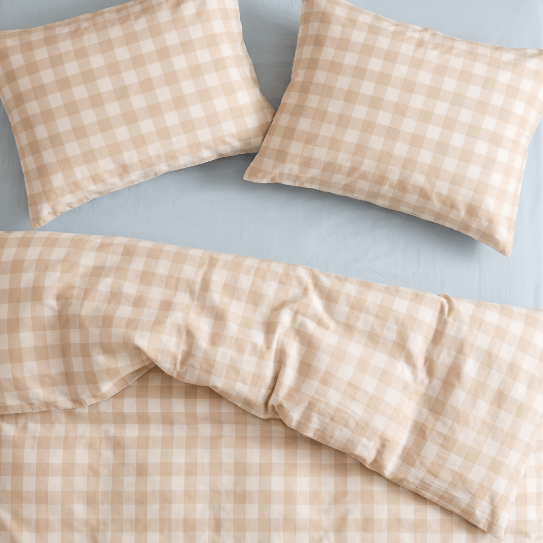 Overhead view of the beige gingham quilt cover and matching pillowcases, showcasing the coordinated checkered pattern, smooth fabric, and neatly styled bedding.