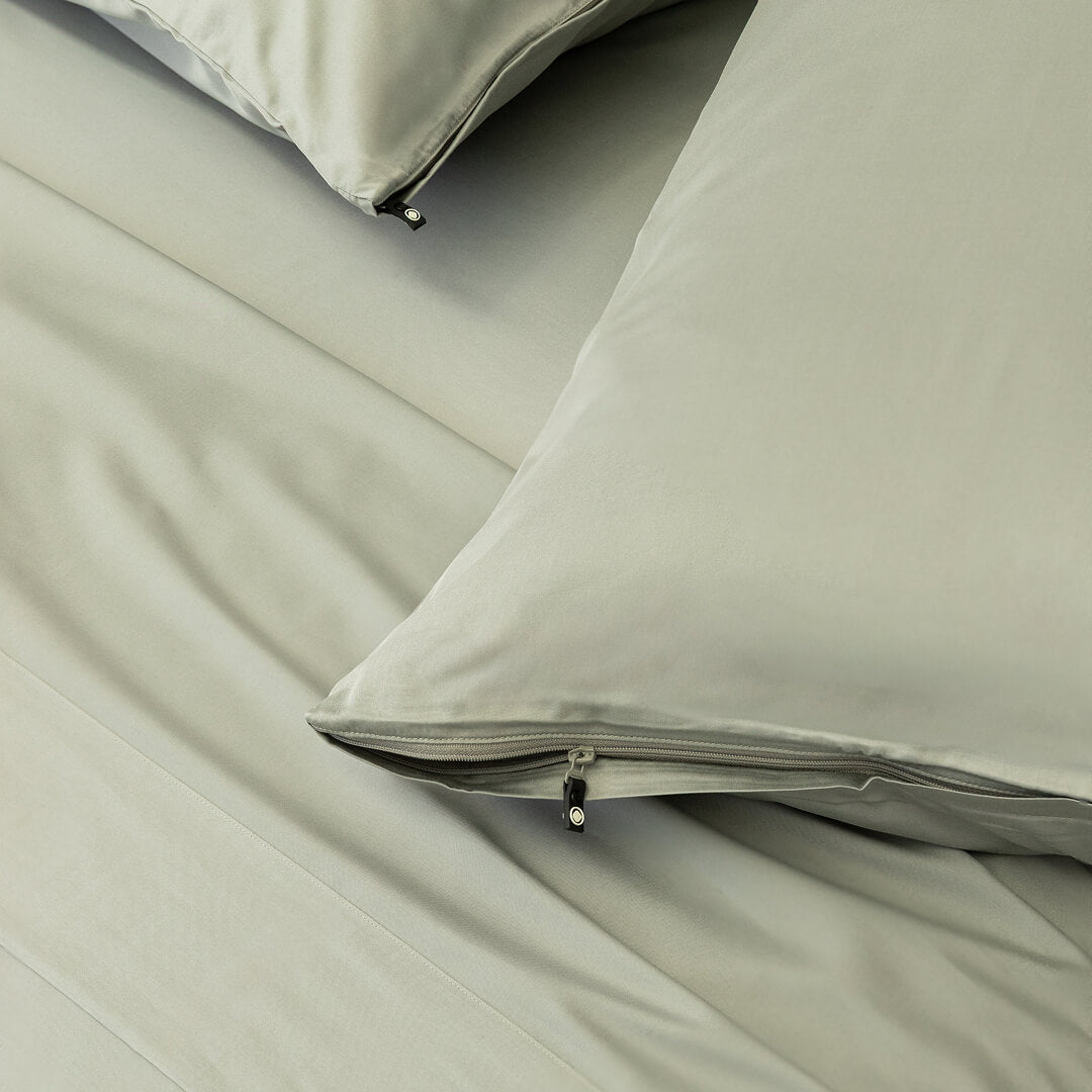 Light grey pillowcases with zips.