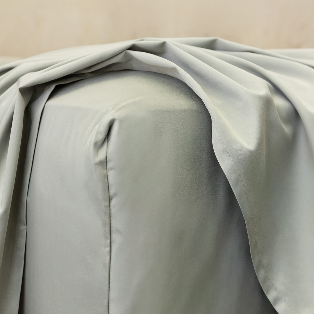 Light grey fitted sheet corner.
