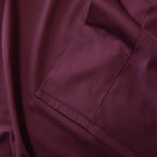 Close-up of a burgundy fabric folded over itself.