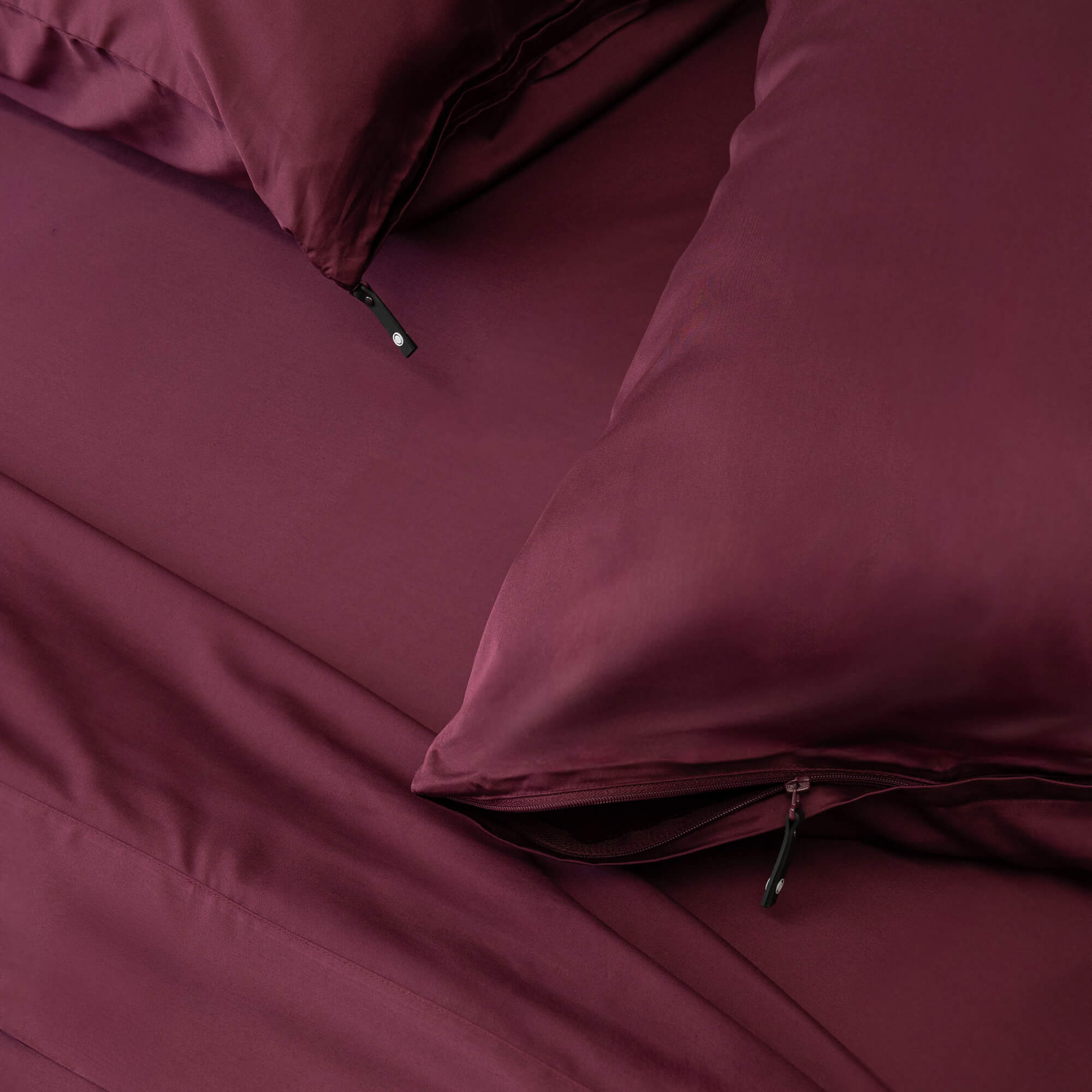 Close up of pillows and pillowcases with zip detail in Lady Musgrave Maroon