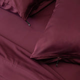 Close up of pillows and pillowcases with zip detail in Lady Musgrave Maroon