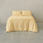 Yellow waffle-weave quilt cover set made up on a double bed with two matching waffle pillowcases