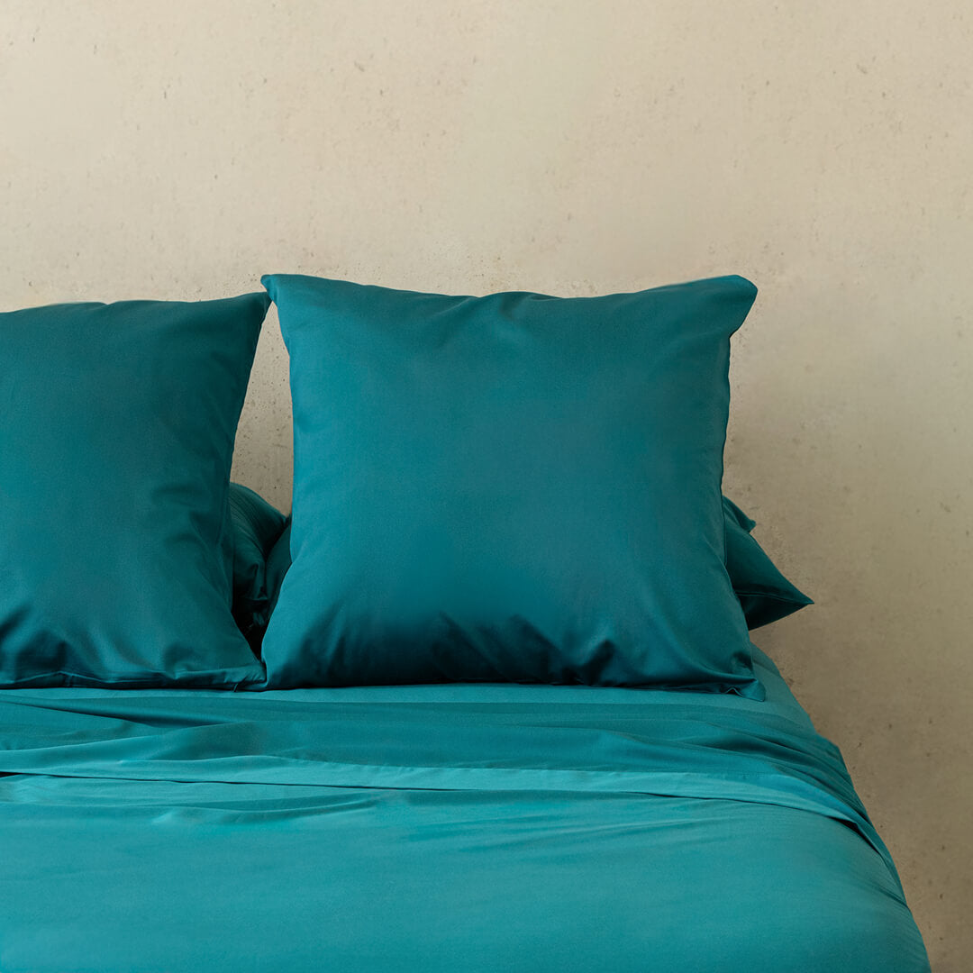 Teal bedding, featuring European pillowcases.