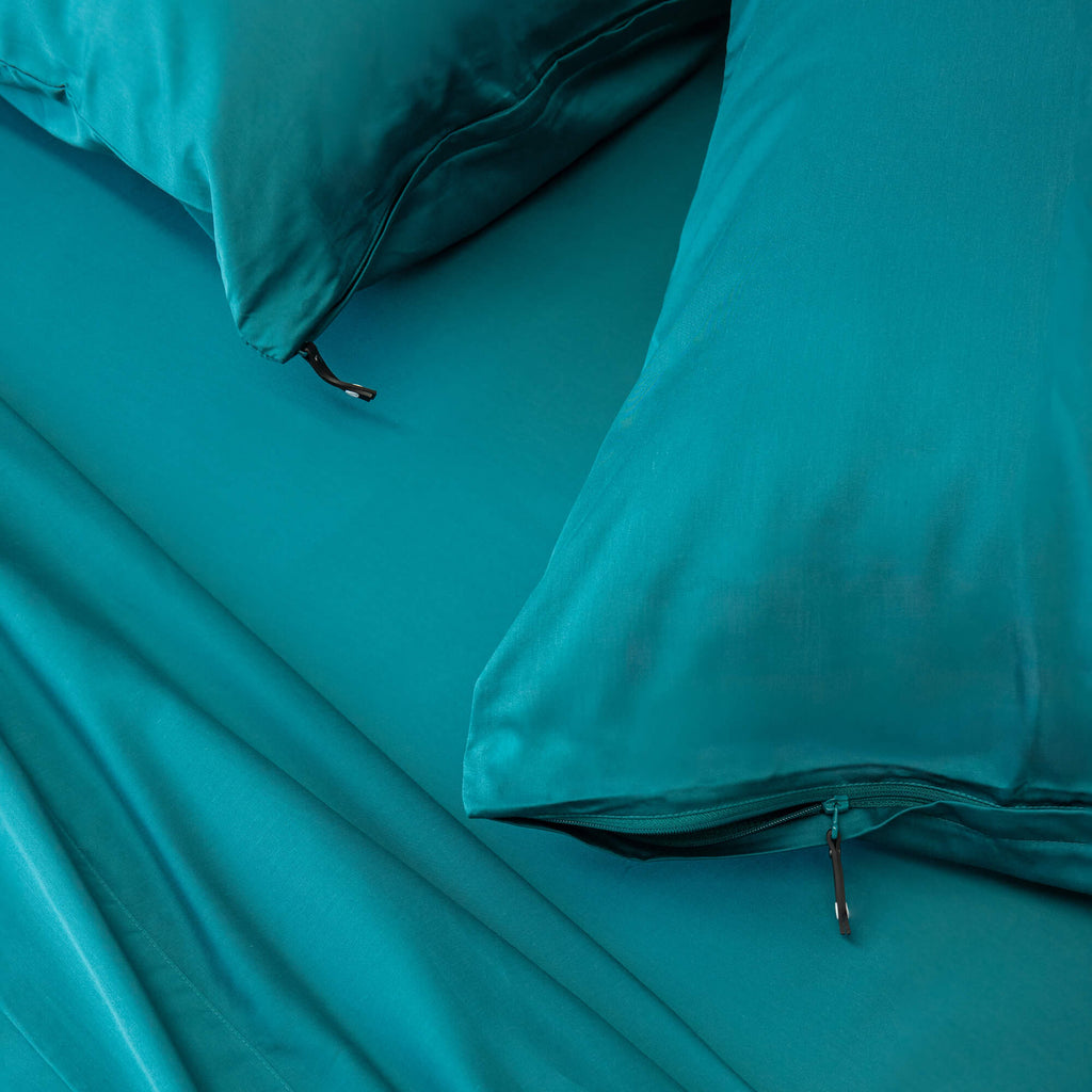 Close up of pillows and pillowcases with zip detail in Teal Bedding

