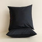 Black pillow on a beige background
