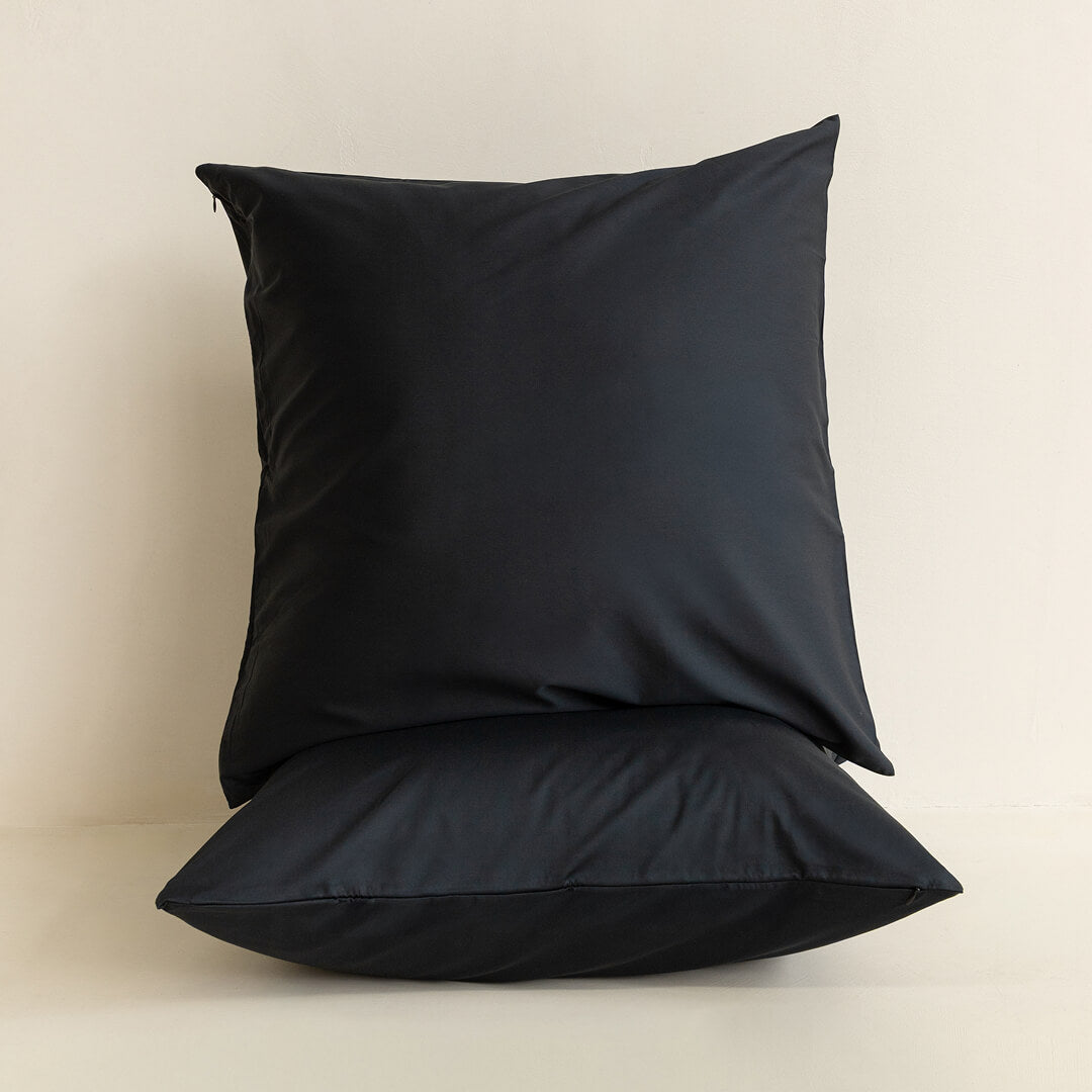 Black pillow on a beige background