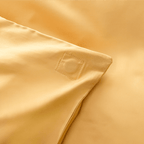 Close-up corner view of golden yellow fabric showing square-stitched corner reinforcement detail