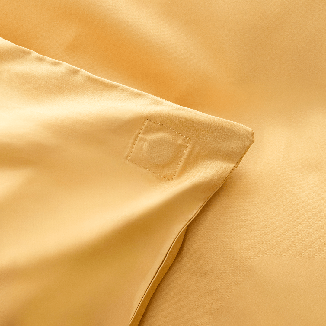 Close-up corner view of golden yellow fabric showing square-stitched corner reinforcement detail