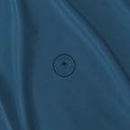 Blue fabric with a circular logo in the centre.