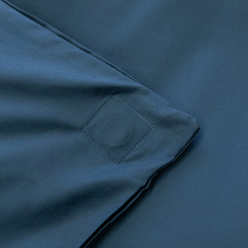 Close-up of a blue fabric with a magnetic clip detail.