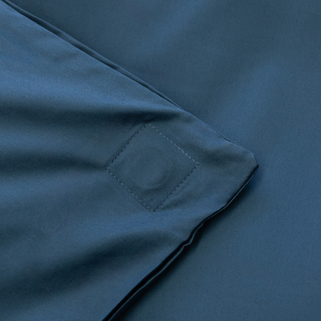 Close-up of a blue fabric with a magnetic clip detail.