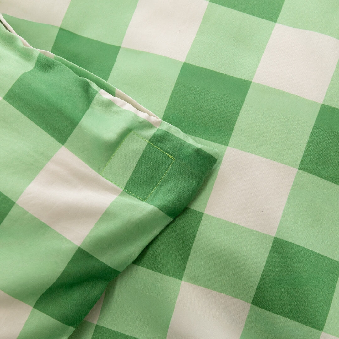 Meadow green gingham print quilt cover magnetic corner close up.