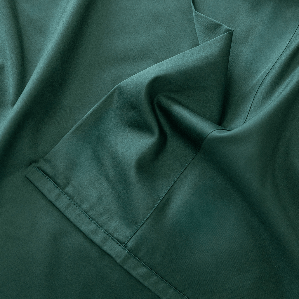 Close-up of dark green fabric with folds.