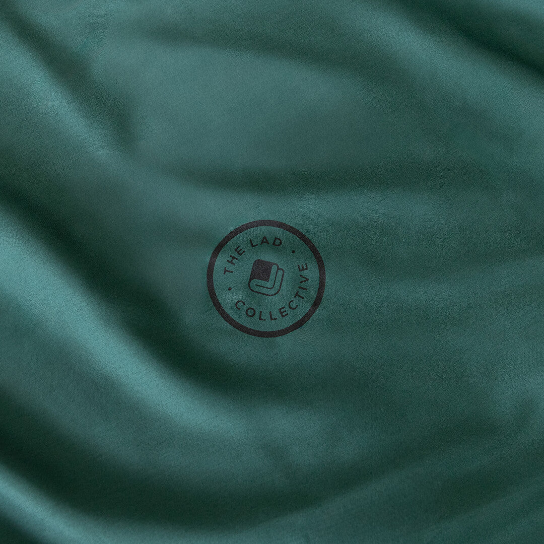 Forest green fabric with a circular logo in the centre.