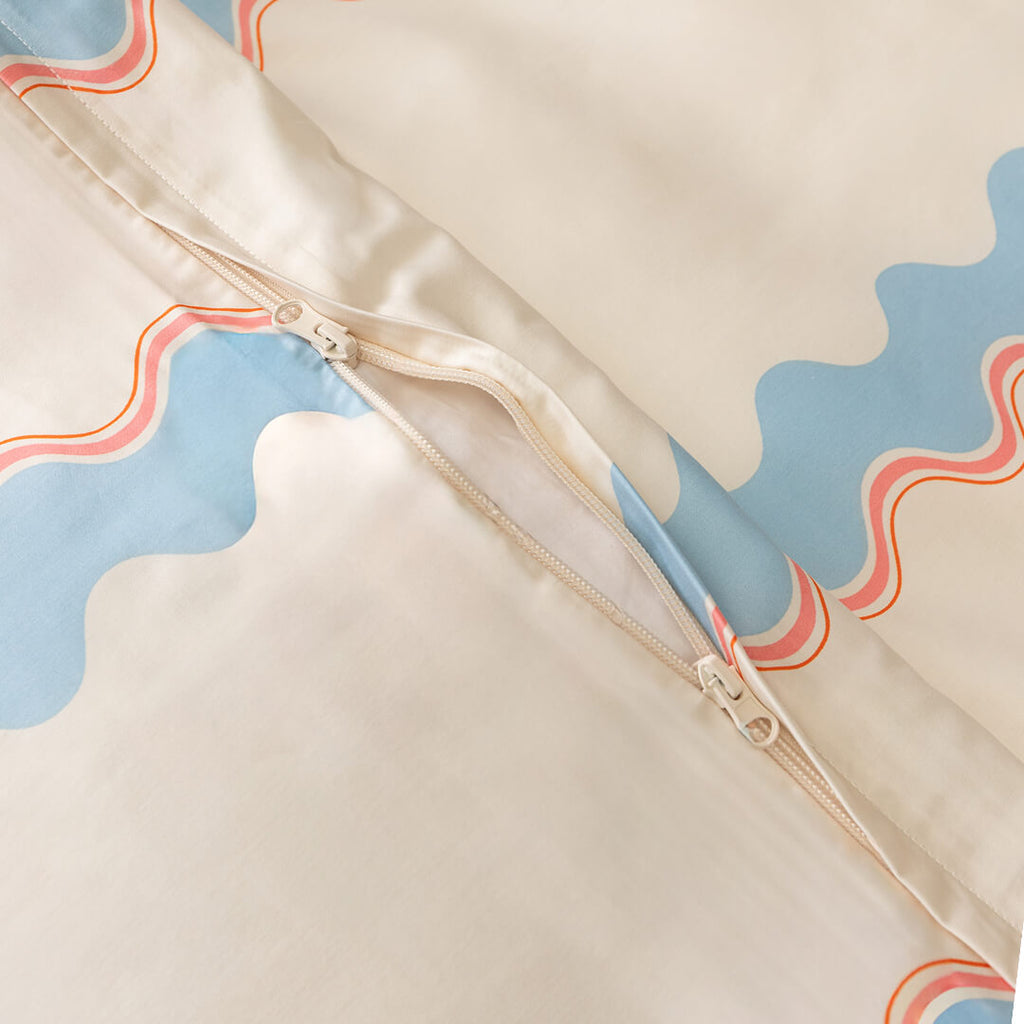 Close-up of a duvet cover with pattern and zipper.