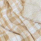 Beige and white checkered blanket with textured wool corner.